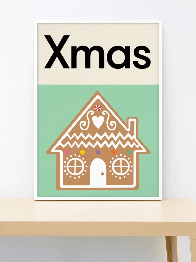 Framed wall print of an illustrated gingerbread house on green background