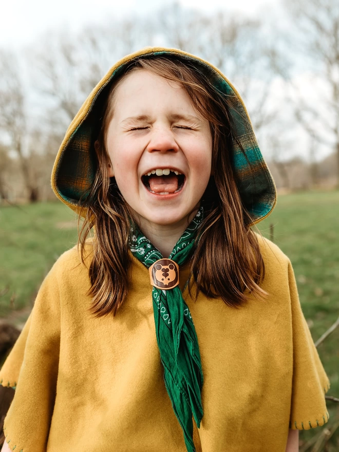 Boy wearing Poncho and neckerchief with leather woggle