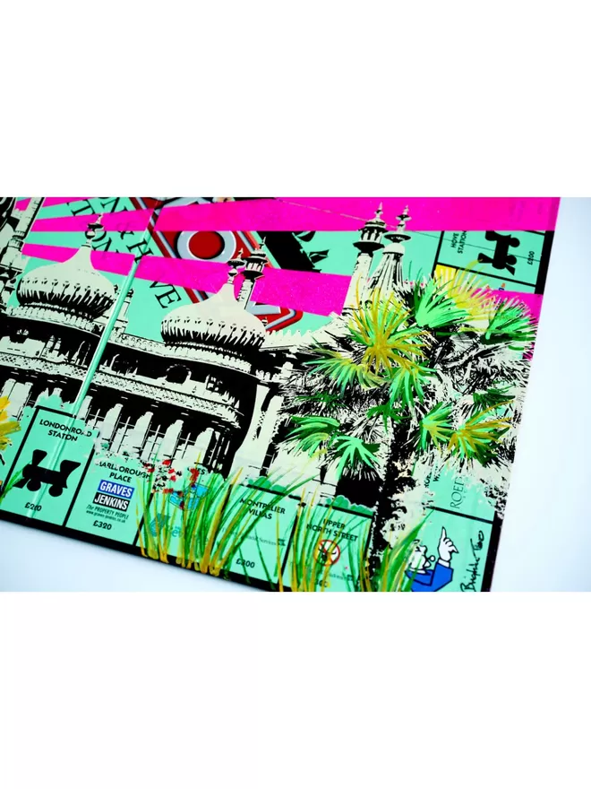 Monopoly Board close up with Brighton Pavilion and palm trees printed on top