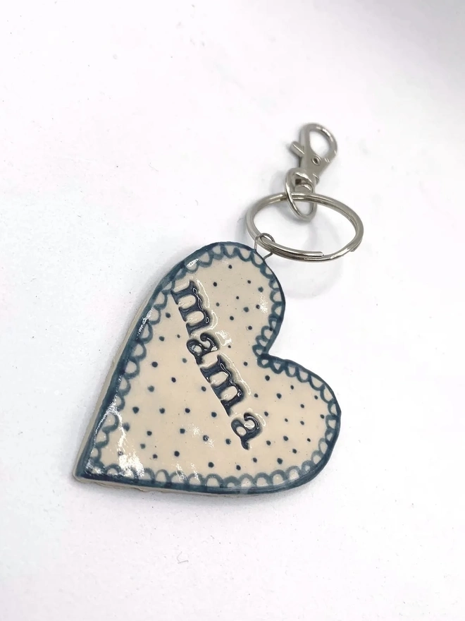 Mama Heart Ceramic Keyring, a blue keyring sitting on a plain white surface. 