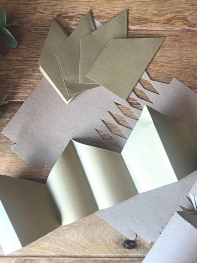 personalised calligraphy christmas crackers. gold paper christmas crowns.
