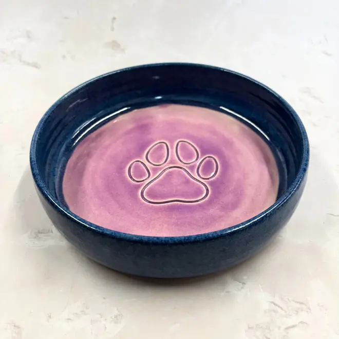 Landscape Dog Bowl, a colourful dog bowl sitting on a stone surface. 