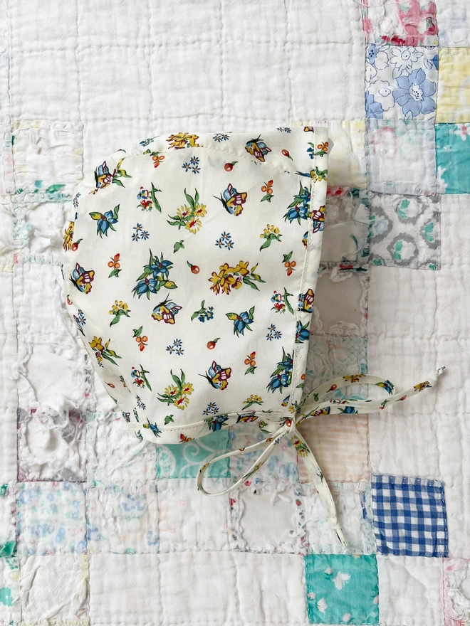 Liberty baby bonnet on vintage eiderdown
