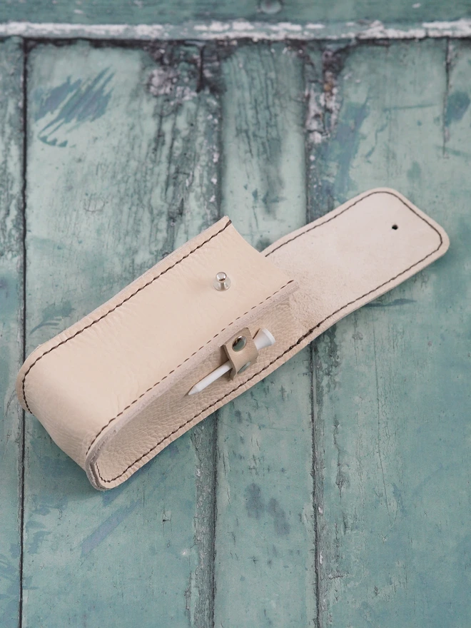 Handmade leather golf ball carry case. Small leather pouch in natural cream suitable for holding 3 golf balls and 2 tees.