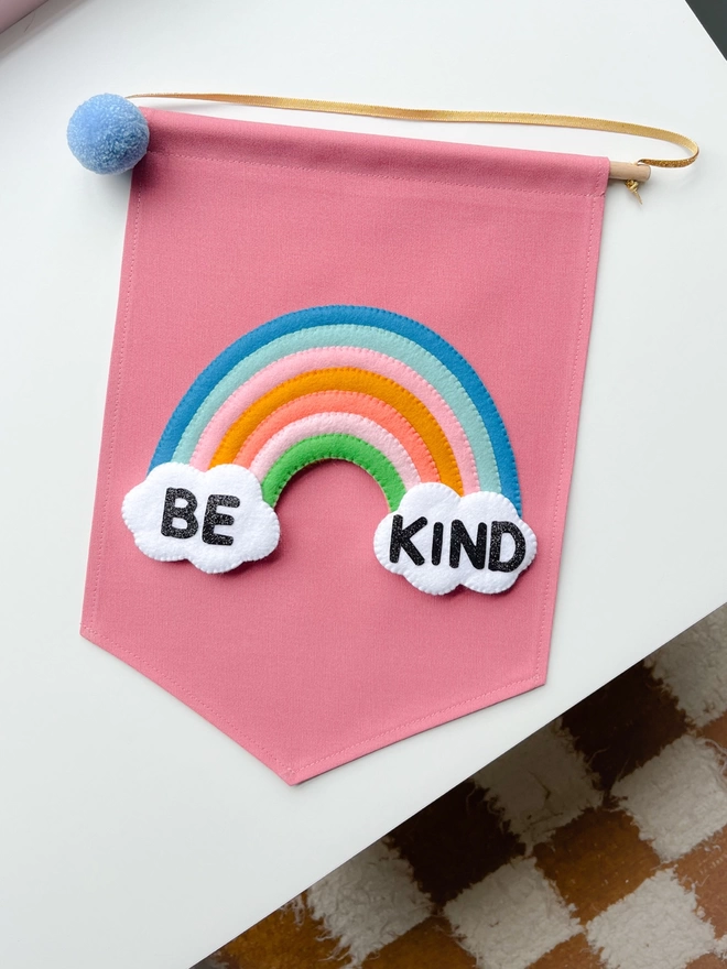 Be kind banner on a white table