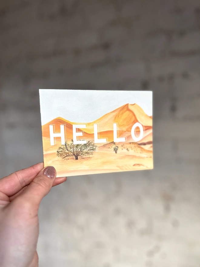 a greetings card featuring an illustration of some of the Everglades landscape with the text “hello”