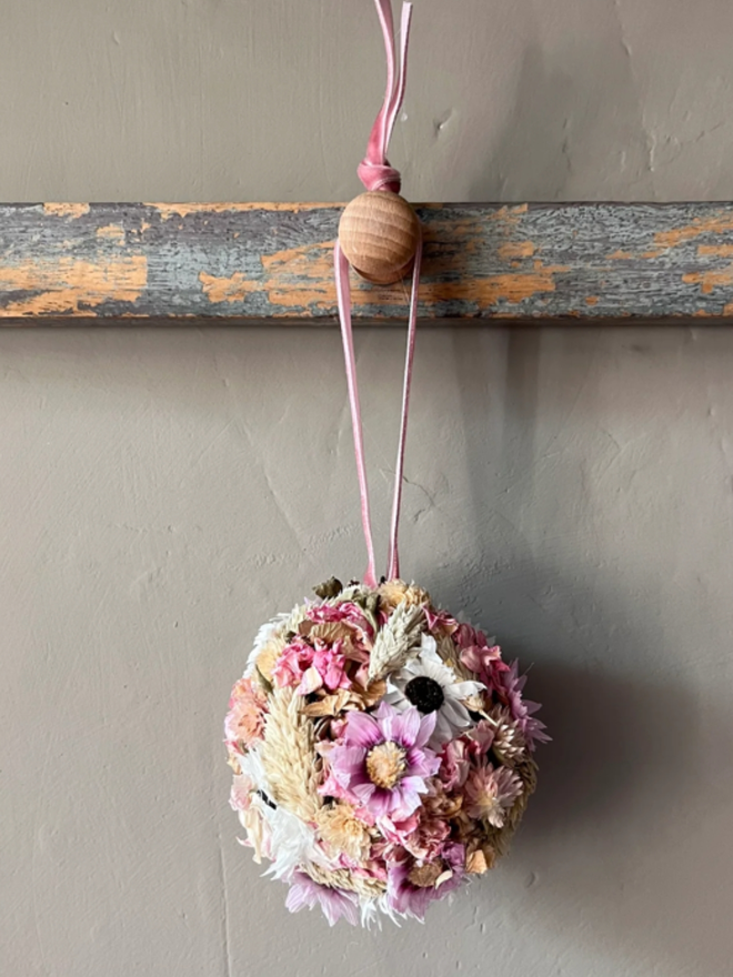 Pink Bauble. A bauble made of dried flowers in pinks and whites.