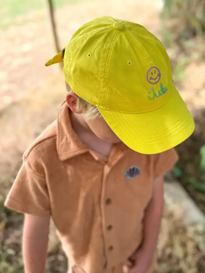 Boy wearing yellow hand-embroidered cap