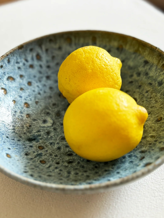 Pasta Bowl. A bird’s-eye view of a blue pasta bowl, filled with two lemons.