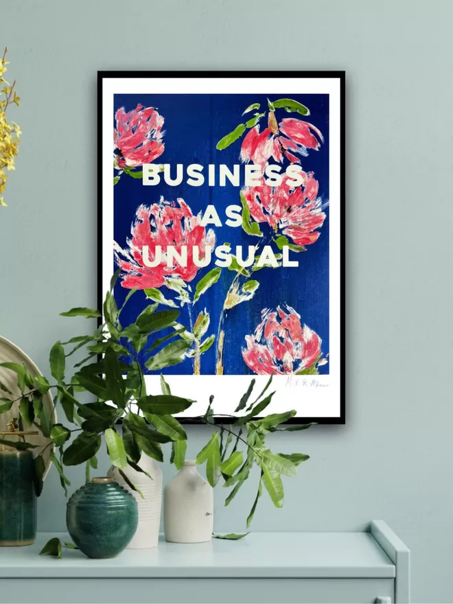 BUSINESS AS UNUSUAL fine art print.  Based on an original monoprint by M.E. Ster-Molnar.  Shown a pale green wall with house plants.  