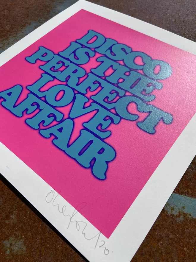 "Disco Is The Perfect Love Affair" Mini Screen Print with pink background and the words disco is the perfect love affair printed on top in blue 