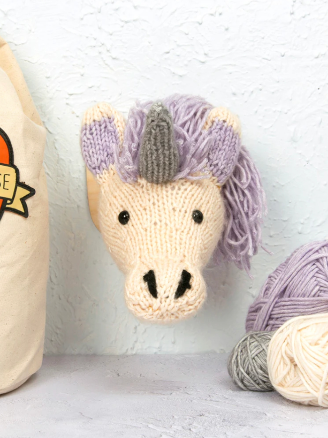 Mini Unicorn Head Knit Kit. A unicorn head with lilac hair and a silver horn