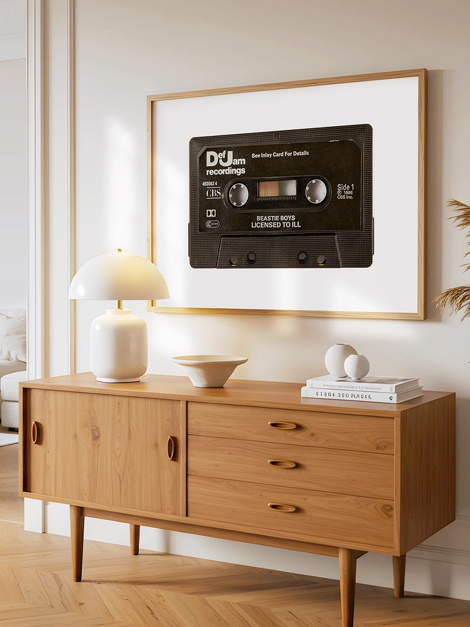 beastie boys license to iii cassette tape print. print framed above wooden dresser.