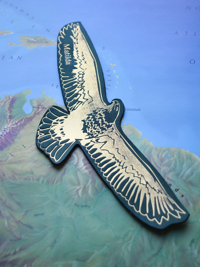 a forest green leather gold eagle bookmark by natthakur on a map of Central America personalised with the name Matilda