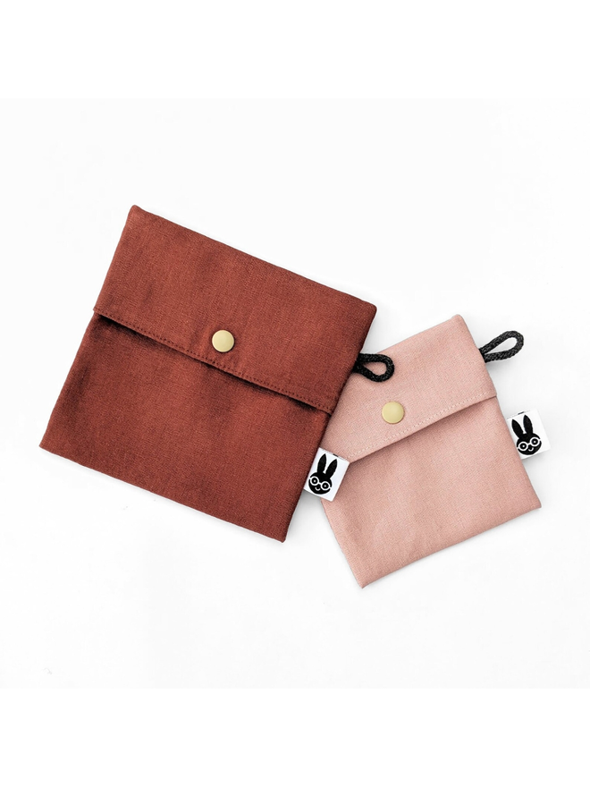 reusable linen snack pouch. two snack pouches in different sizes, one brown and one pink.