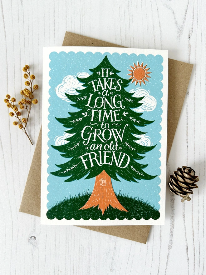 old friend pine tree card with cone and flowers