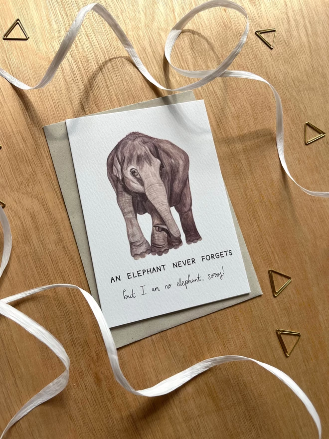 a greetings card featuring an illustrated elephant with the phrase “an elephant never forgets but I am no elephant - sorry”