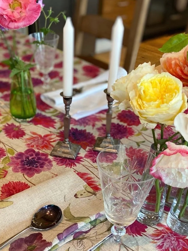 Dahlia Tablecloth. A tablecloth printed with vibrant pink flowers.