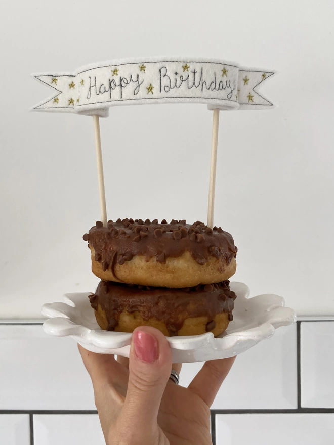 Star Banner Cake Topper in two chocolate doughnuts with tile background