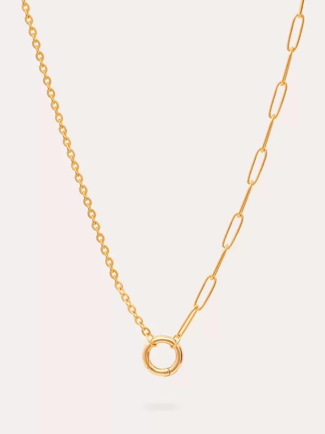 still life image of a heavy mixed chain gold necklace
