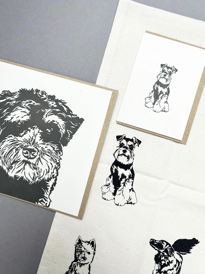 Big and little Schnauzer card on top of the puppies tea towel