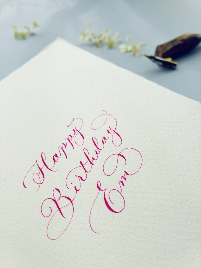 pink calligraphy lettering on a birthday card