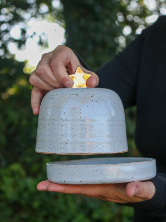 holding the butter dish lid by the gold star