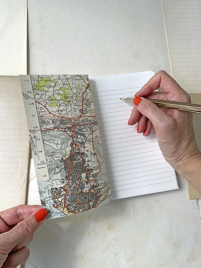 writing on first page of linen map travel notes