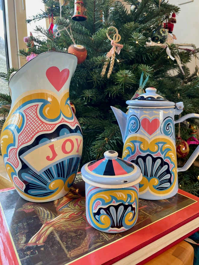 Collection of enamelware hand painted with fairground designs