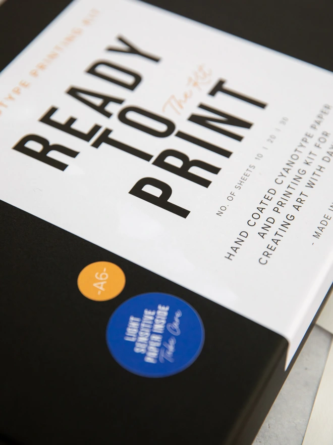 close up of cyanotype printing kit box, showing the label that reads "ready to print - the kit"