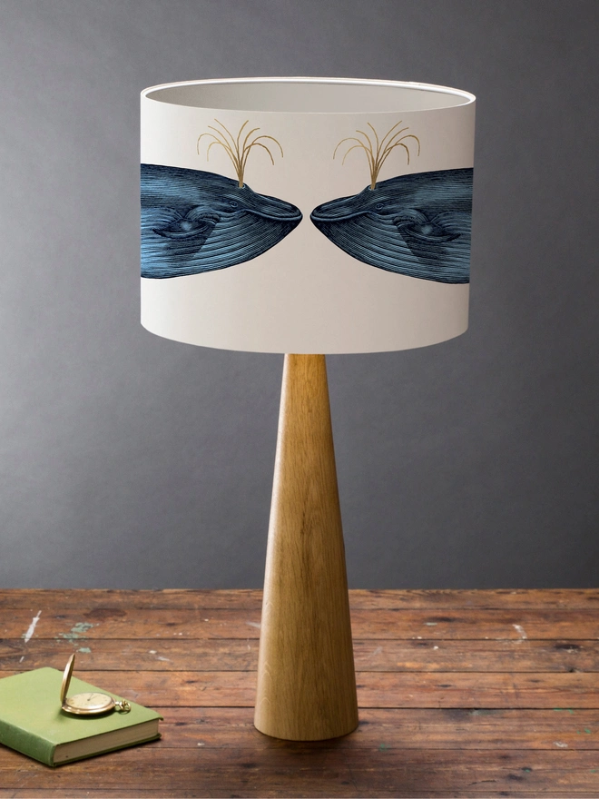 Handmade blue whale lampshade with gold details featuring vintage inspired ocean artwork