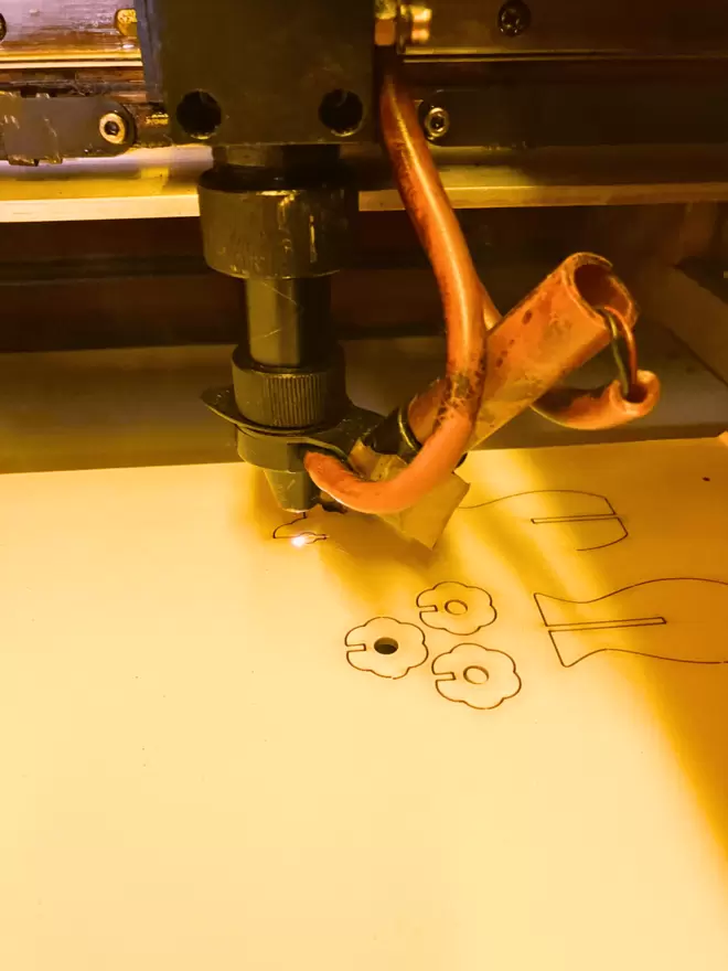 A laser cutting machine laser cutting a vase of flowers decoration