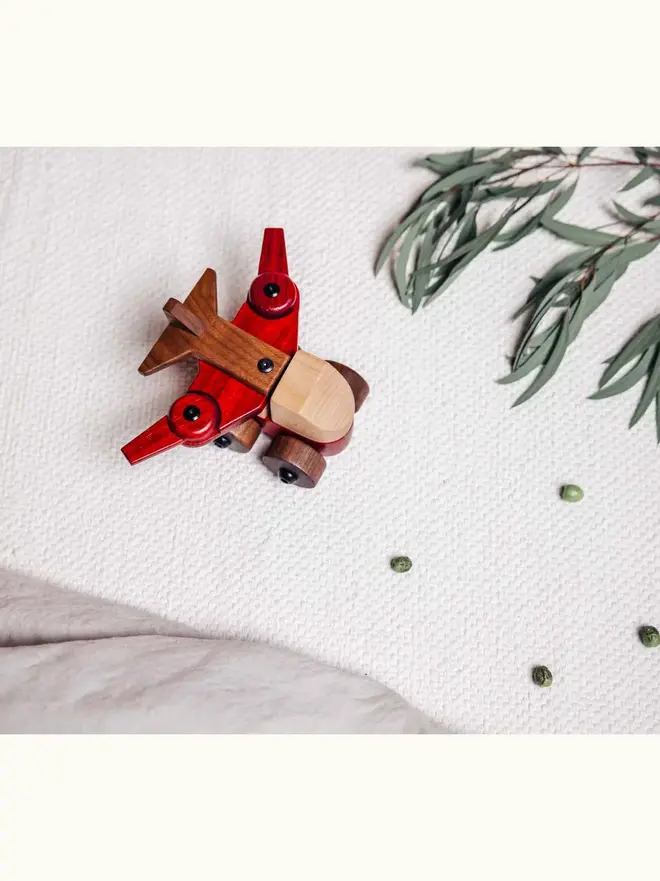 Walnut & Padauk Aeroplane Wood Heirloom Toy, on a table. 