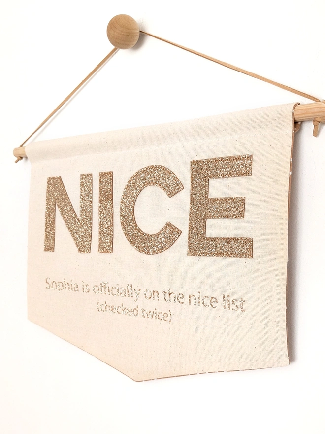 Nice appliqued on a banner in gold glitter fabric, fresh from Santa's nice list
