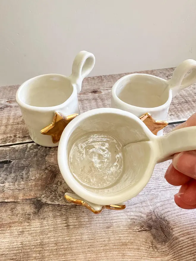 Porcelain Tea Light Holder Cup, set of three tea light holders stacked on a table. 