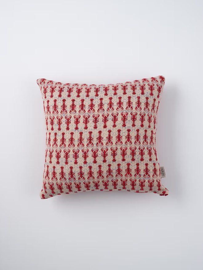 lobster square cushion. a square cushion embroidered with lobsters photographed on a plain background.