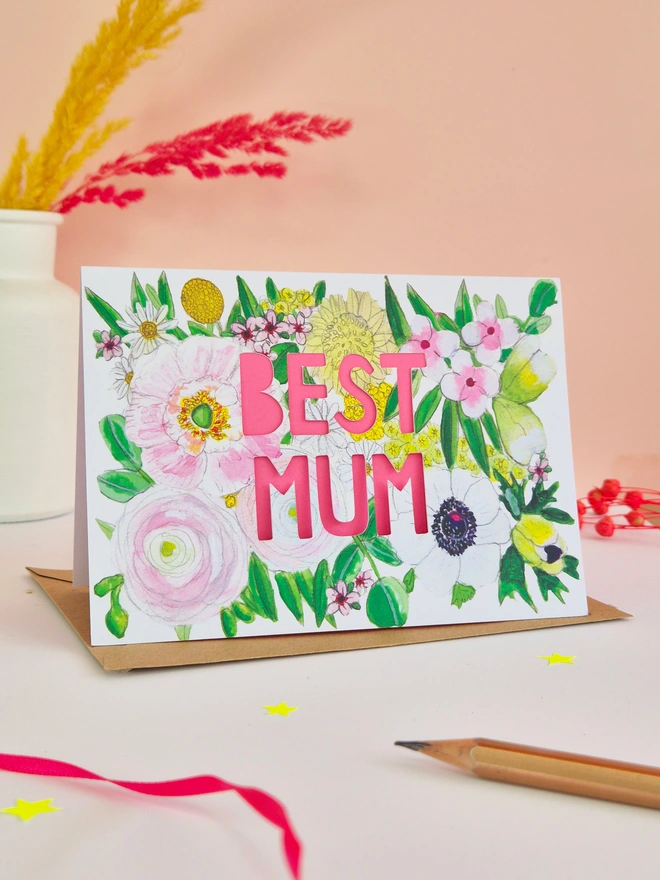 Best Mum Card with paper cut text, bright pink backing paper and a gorgeous floral illustration
