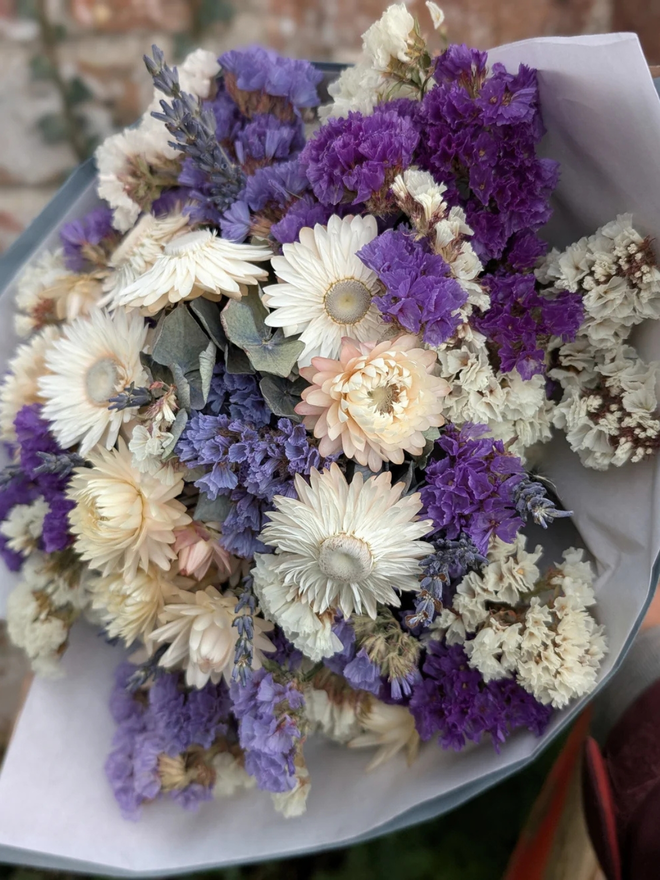 lavender sea spray dried flower bouquet. bouquet of purple dried flowers wrapped in paper.