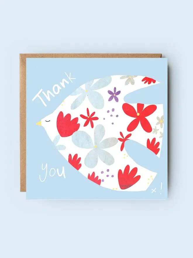 floral dove illustrated thank you card. card photographed against plain blue backdrop.