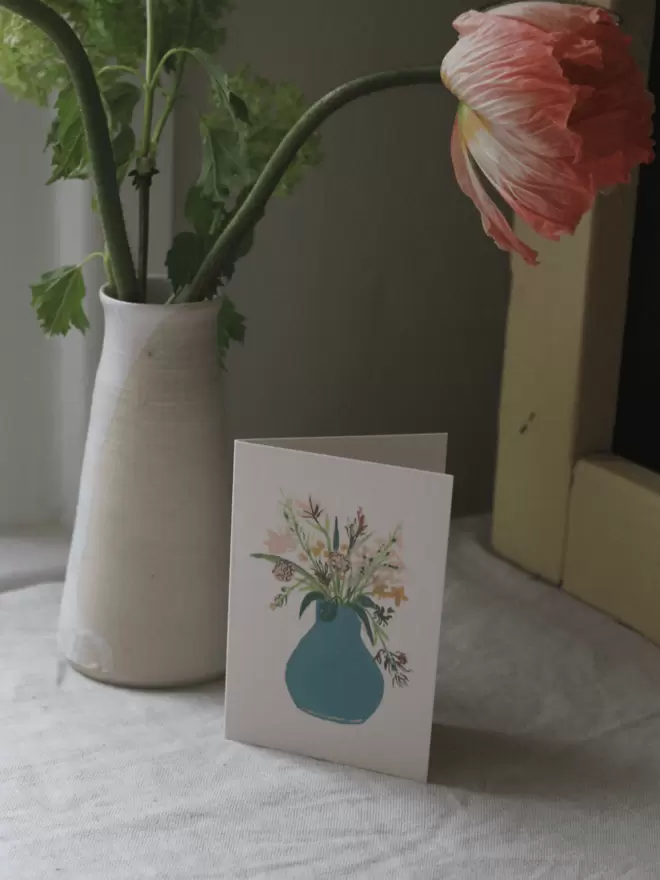 greeting card with mixed flower bunch in a blue vase 