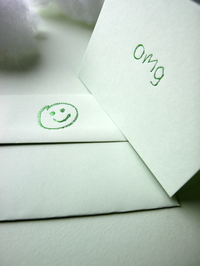 pistachio coloured card with omg short for 'oh my god' hand foiled in kids hand writing