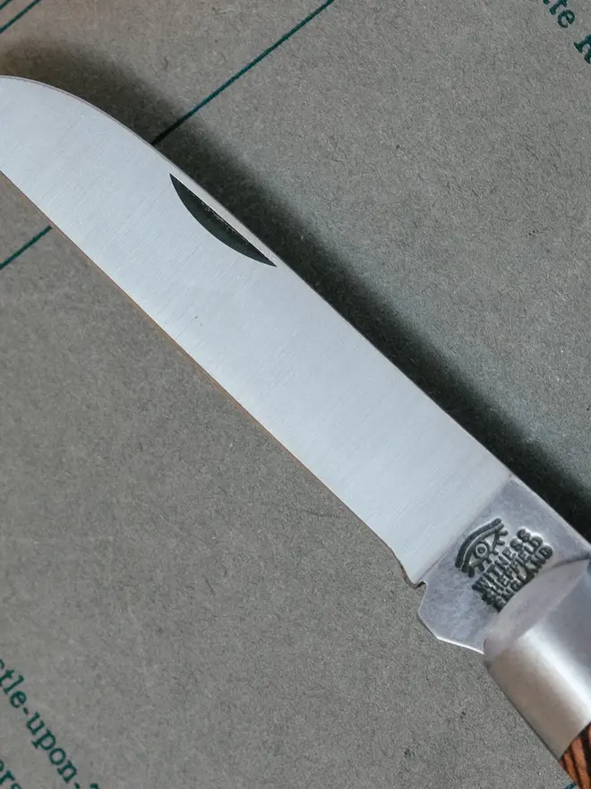'the cheviot' folding pocket knife. a close up image of a steel knife blade.