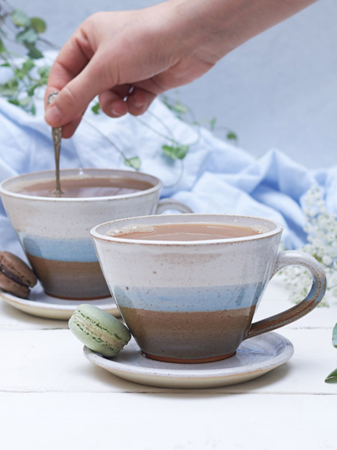 brown and white ceramic mug and saucer