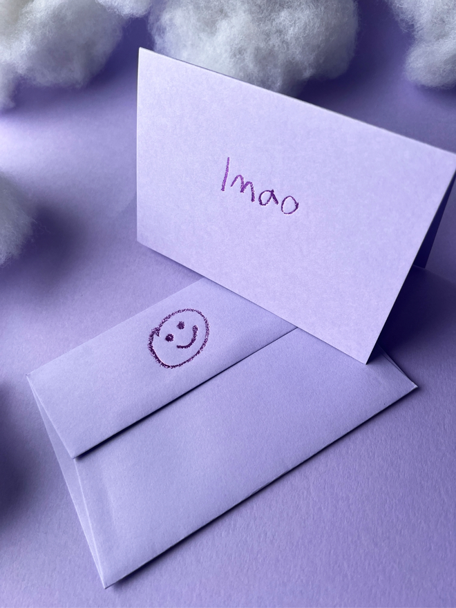 lavender coloured card with lmao  short for 'laugh my ass off' hand foiled in kids hand writing