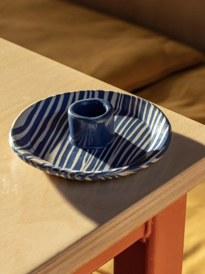 Ceramic Patterned Candlestick Holder, a colourful candlestick holder sitting on a table top surface. 