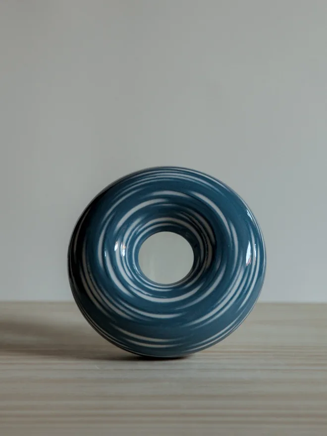 Handmade porcelain avocado planter with carved blue pattern, designed to hold an avocado seed for sprouting