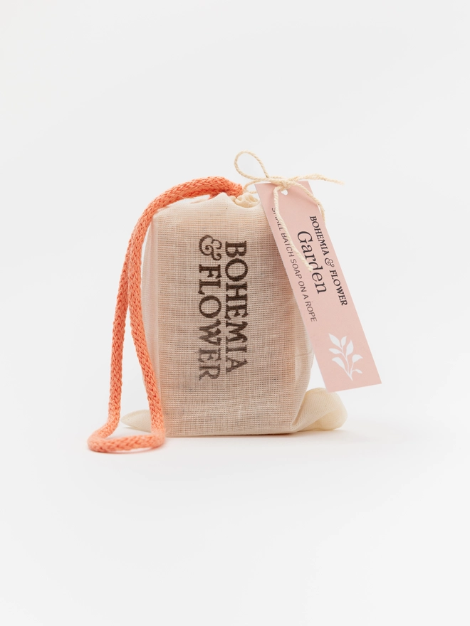 Garden Soap on a Rope hanging by its colourful British-made rope – a floral pink clay soap designed for the shower, ideal for eco-friendly gifting or gym-friendly self-care