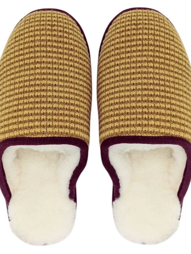 Lambswool & Sheepskin Slippers, a pair of colourful lambswool and sheepskin slippers sitting on a plain white surface. 