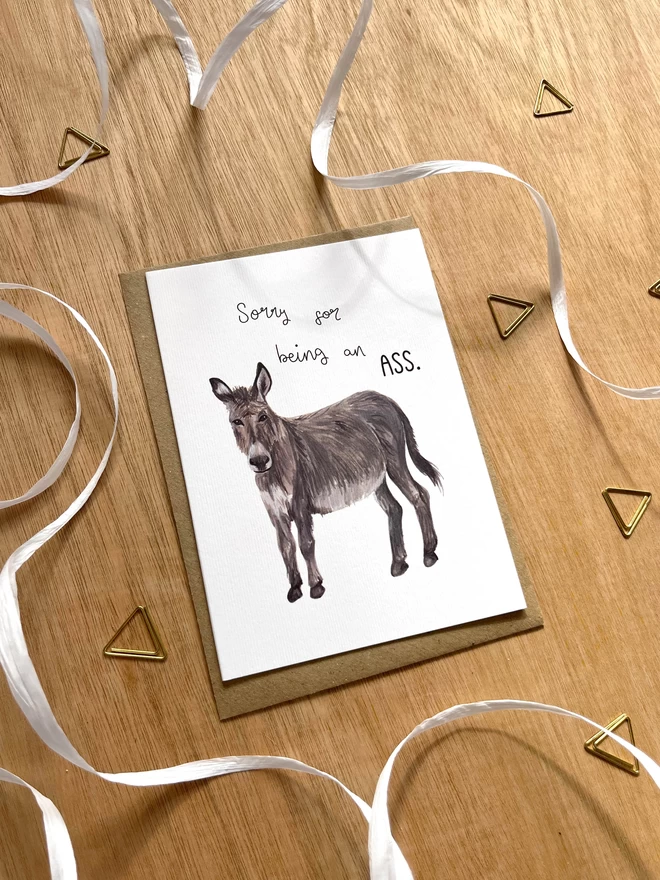 a greetings card featuring a donkey (or ass) with the phrase “sorry for being an ass”