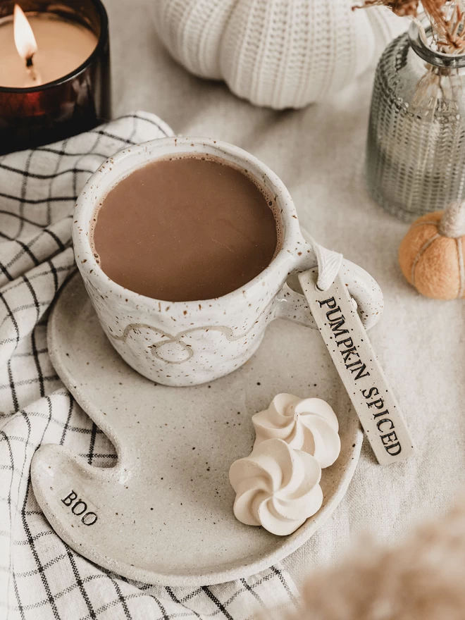 ceramic ghost plate with a mug of tea sat on top